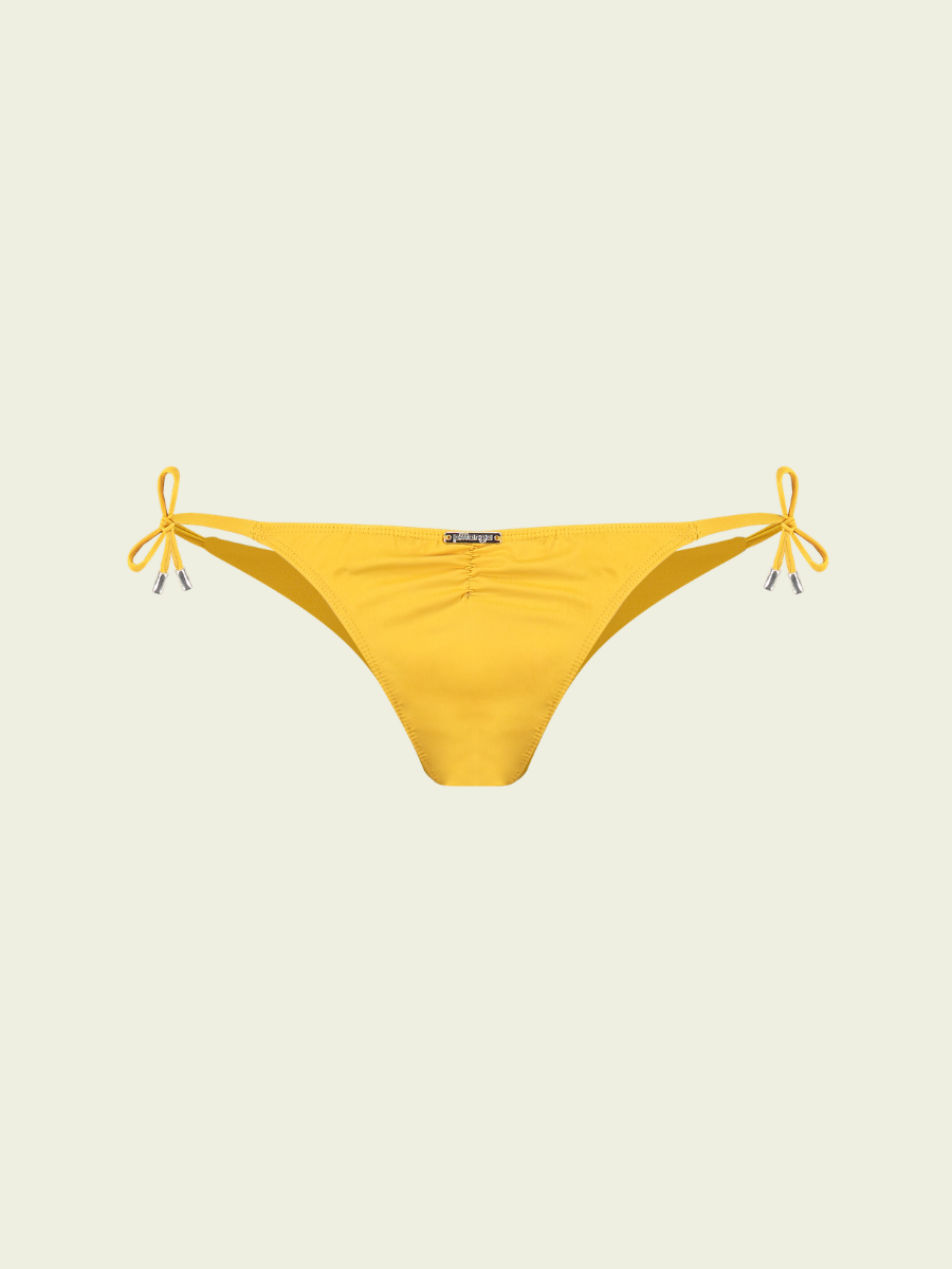 Yellow bikini bottom with bow details on a beige background