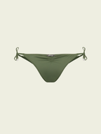 Green bikini bottom with string ties on a light beige background