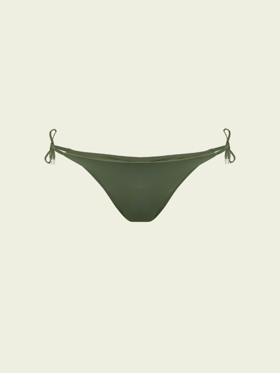 Green bikini bottom with tie sides on a beige background