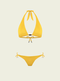 Yellow bikini set on a light beige background