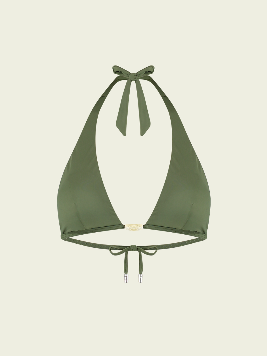 Green bikini top on a beige background
