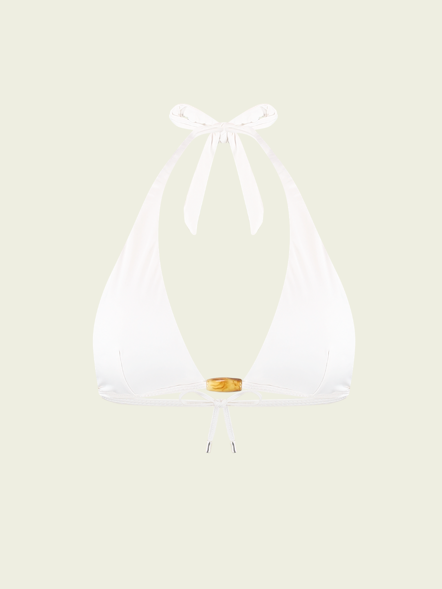White bikini top on a light beige background