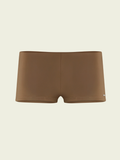 Brown swim briefs on a beige background