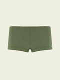 Green boxer briefs on a beige background