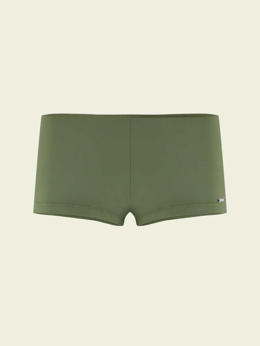 Green boxer briefs on a beige background