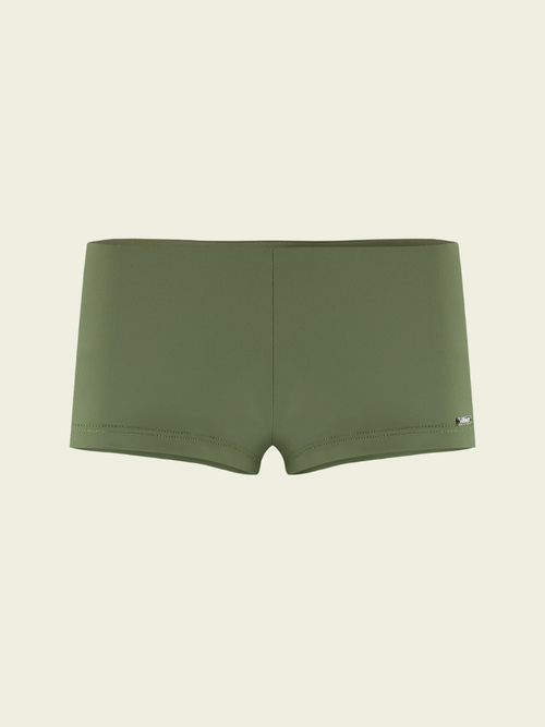 Green boxer briefs on a beige background