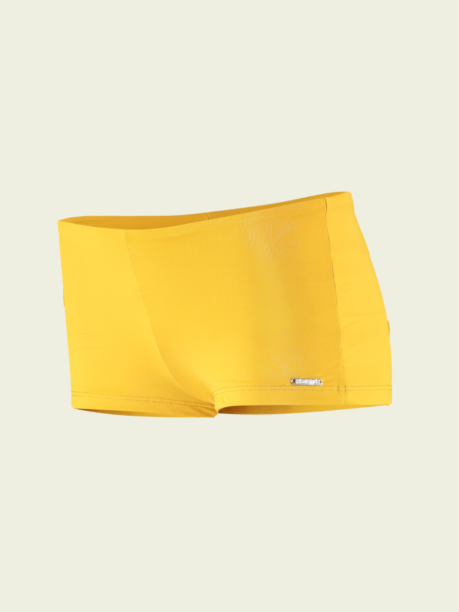 Yellow swim brief on a beige background