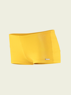 Yellow swim brief on a beige background