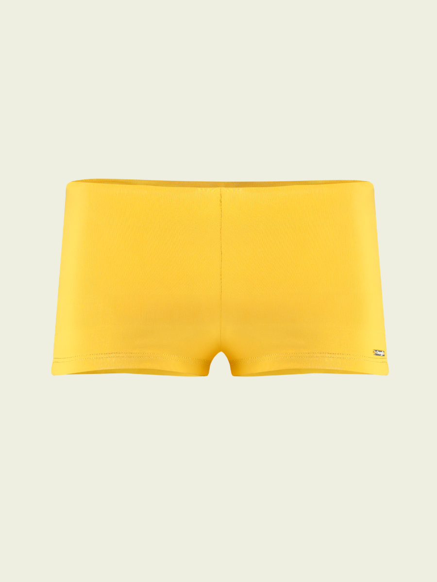 Yellow swim briefs on a beige background