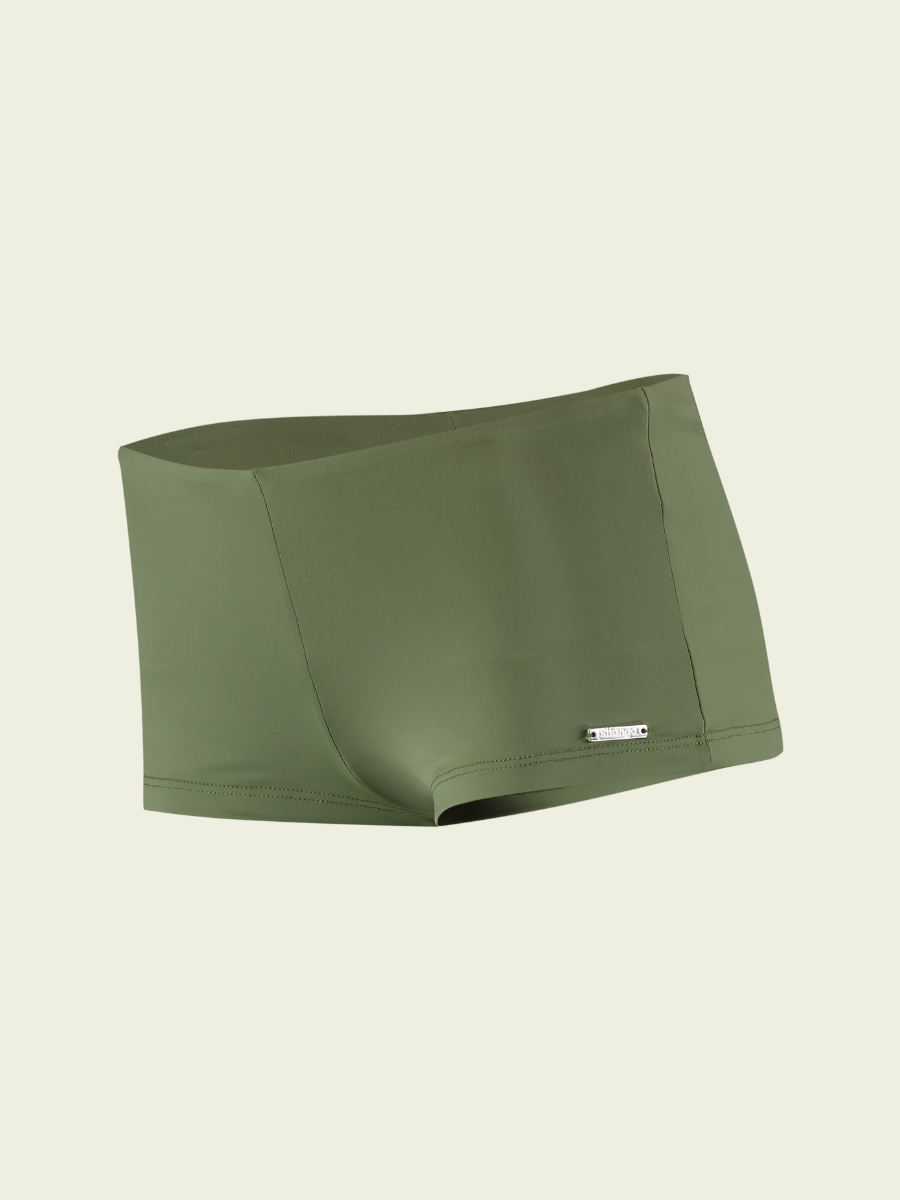 Green athletic shorts on a beige background